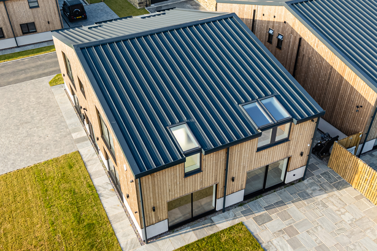  Detailed view of Cladproof clad roofing with skylights at Peat Pitts Farm luxury home 
