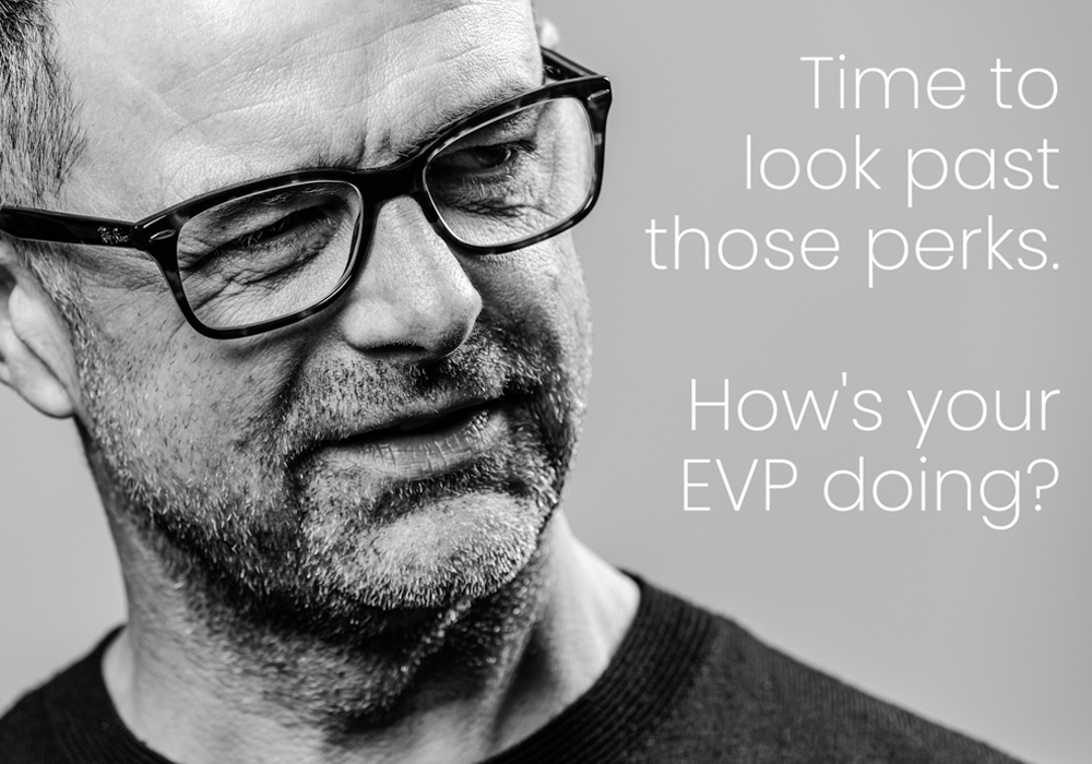 Monochrome close-up of a professional looking thoughtful, overlaid with the text: Time to look past those perks and find out what a strong EVP really looks like.